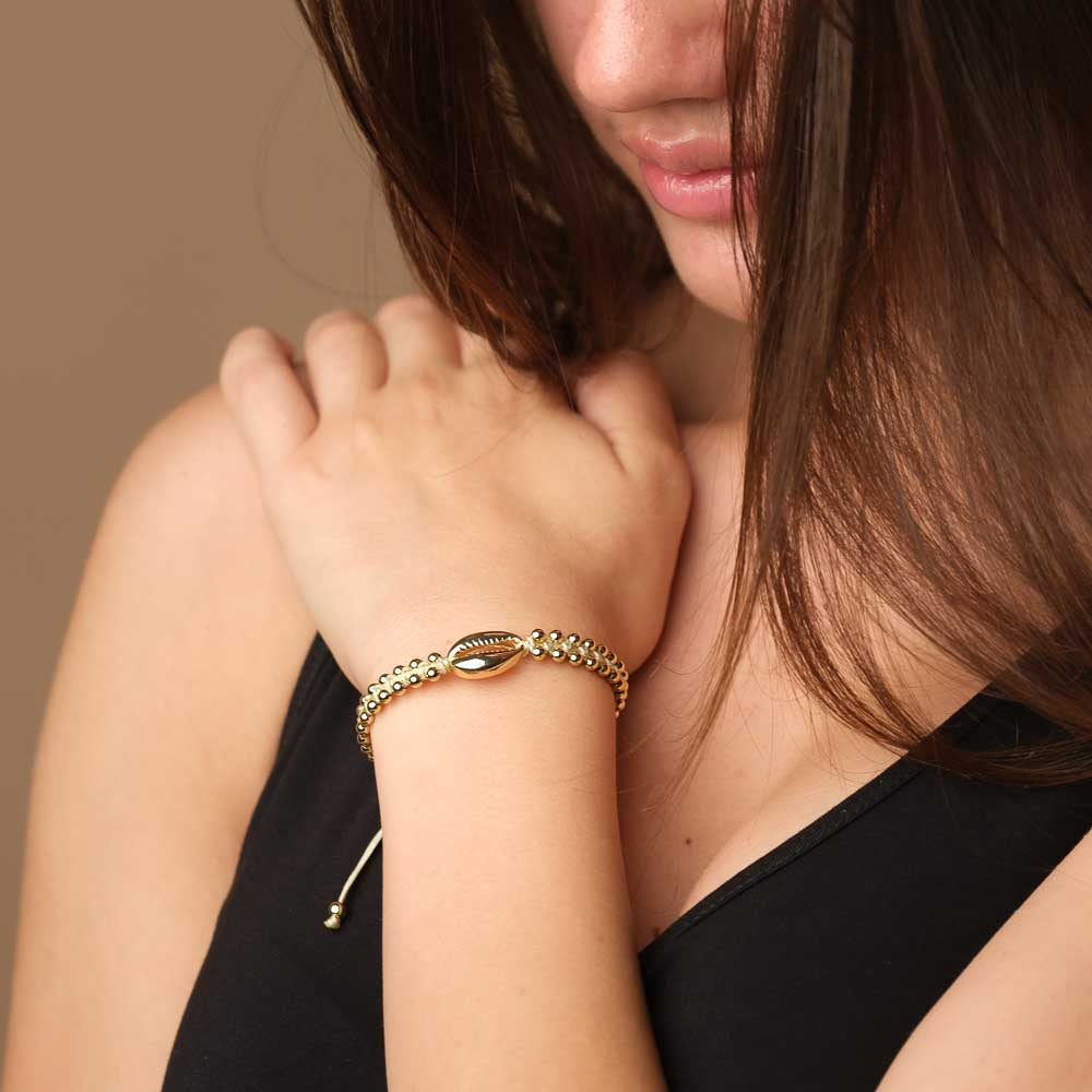 Armband geflochten mit Kauri Muschel gold sand
